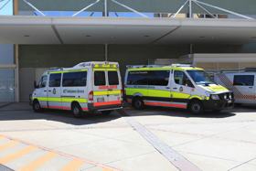 A photo of an ambulance bay at a hospital with two ambulances parked