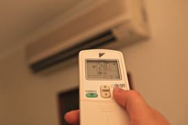 Photo of an air conditioner remote control being set to 28 degrees.