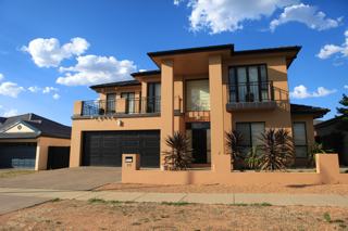 A photo of a modern, large two storey house