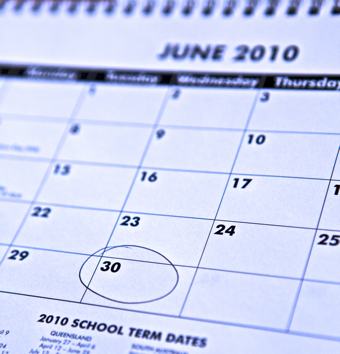 A close up photo of a calendar with the 30 of june circled