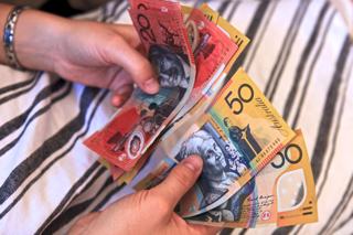 A photo of money on a person’s hand