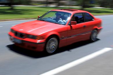 A photo of a modified car travelling at high speed