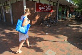 A Photo of a person walking to the shops