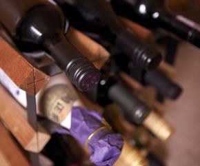 A photo of wine bottles on a rack