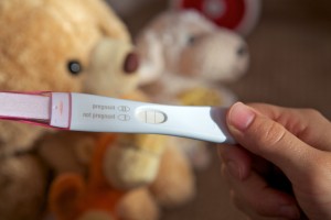 Close up photo of a pregnancy test with the second line indicating a positive result.