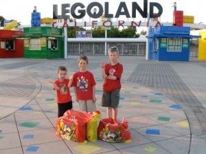 A photo of the three boys standing in front of Legoland California with their recently purchased stash of Lego