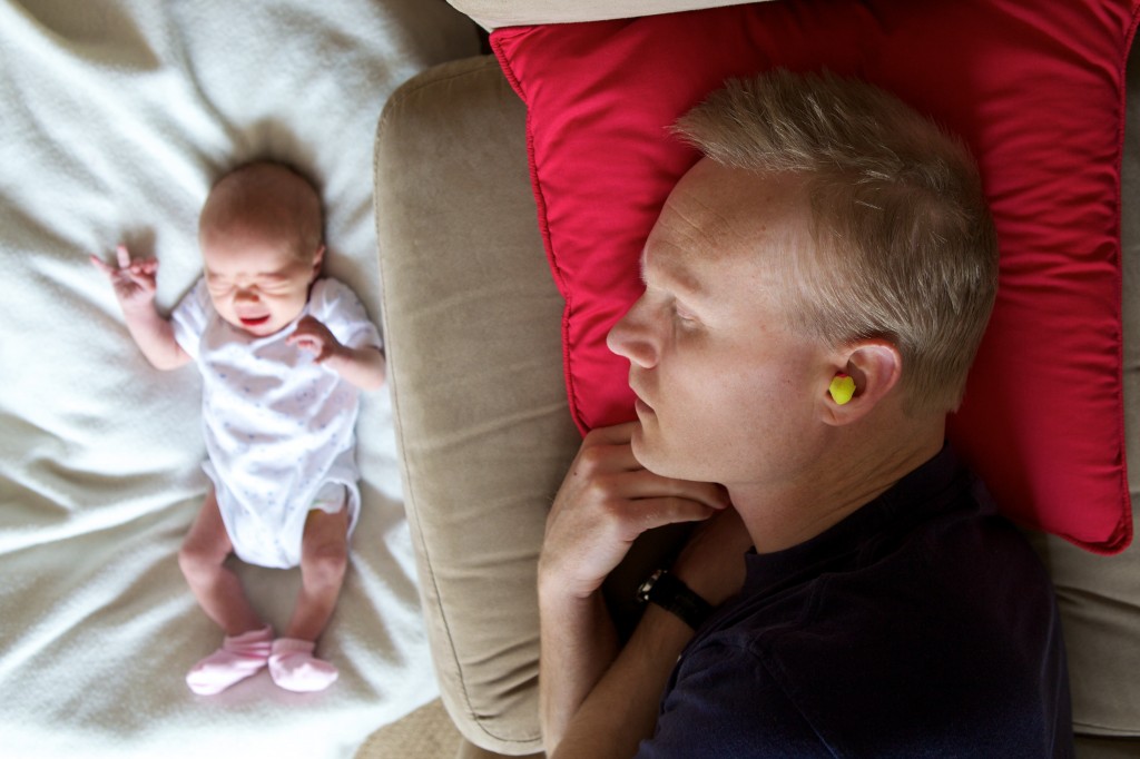 Photo taken above me while I am on the lounge soundly sleeping on my side with earplugs in. Next to the lounge on a rug on the floor is our newborn baby screaming her head off.