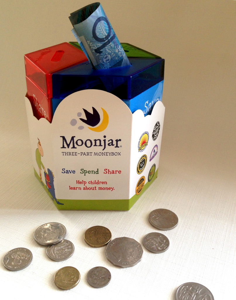 Photo of a Moonjar moneybox showing 3 compartments: one for spending, one for saving and one for sharing.