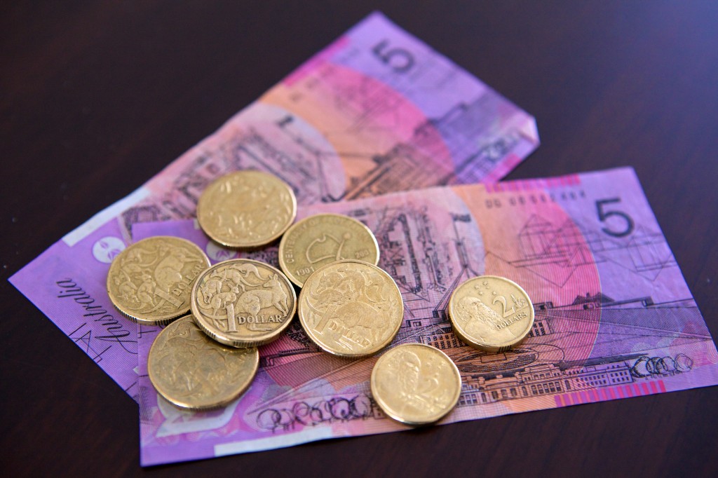 Photo of pocket money consisting of 2 five dollar notes, 2 two dollar coins and 6 one dollar coins. 