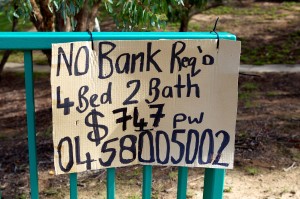 Photo of a dodgy sign that reads "No bank req'd. 4 bed 2 bath $747 p w with a mobile number underneath.